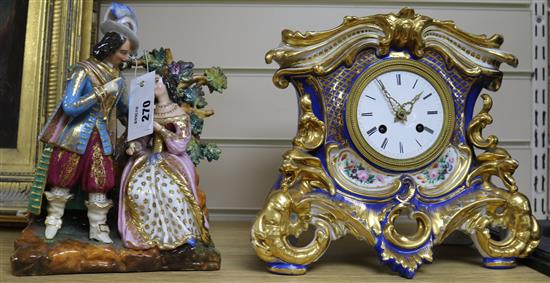 A French porcelain eight day mantel clock, with figural surmount
